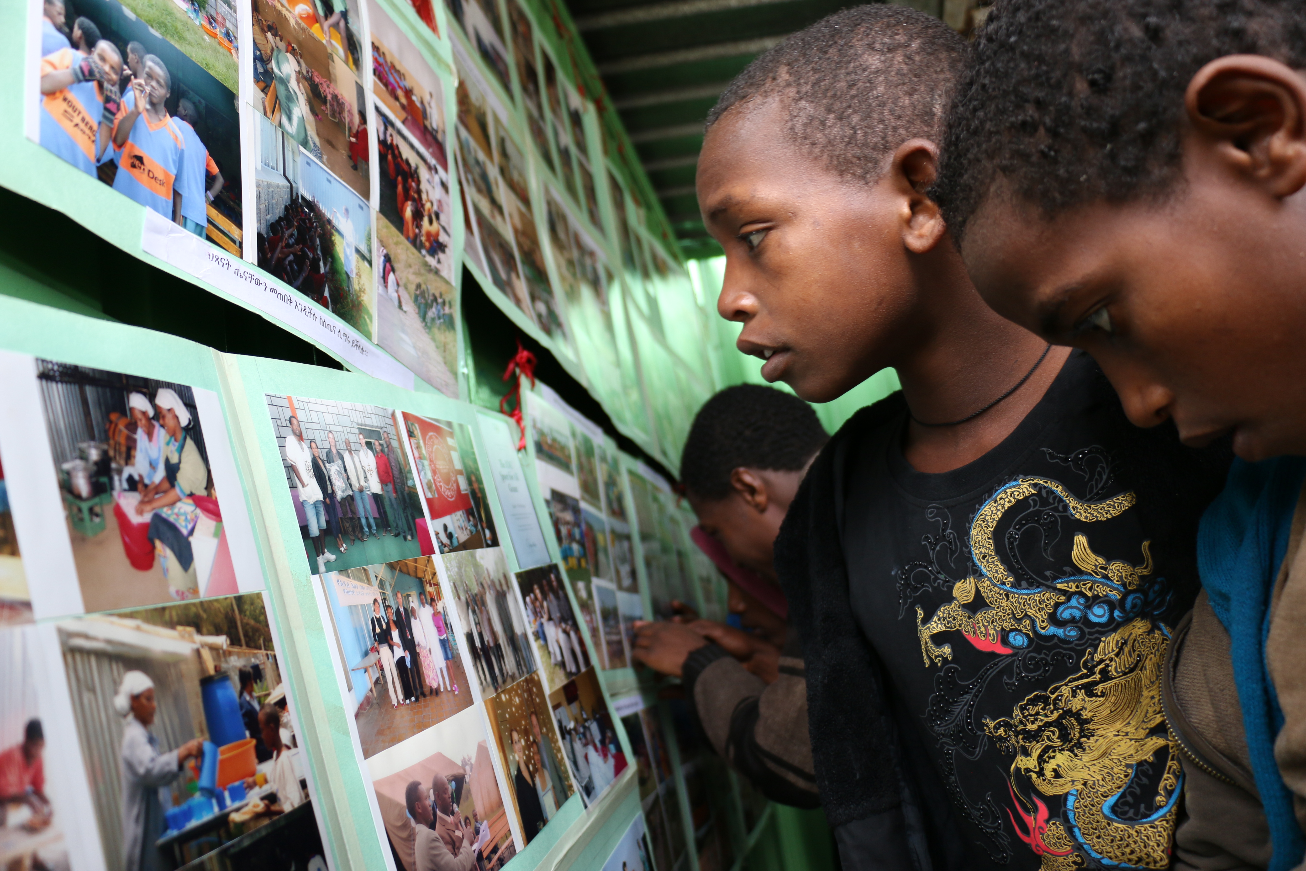 Follow up children (former street children) looking at 10 year photo exhibition